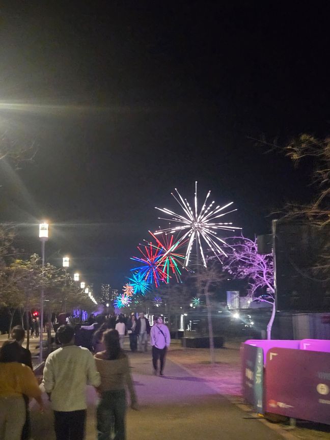 Lights by a pedestrian walkway which resembles fireworks by the way light strips are animated.