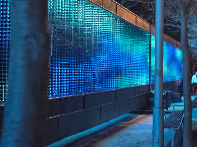 Visual illusion creates by panels of lights, where on an angle it looks like a full screen.